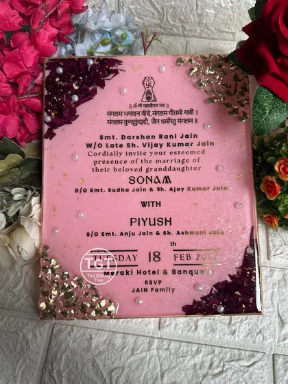 Your wedding invitation can be a work of art. We preserved this 8x10 inch invitation in resin with a glittery baby pink base. The corners are decorated with real rose petals and delicate stones to create a royal and elegant keepsake of the first step in your journey together.