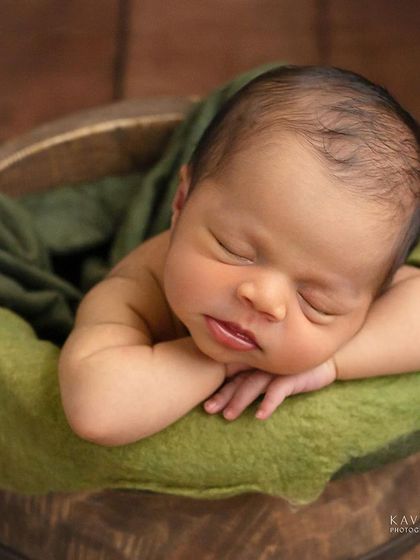 Another angle of six-day-new Anshu, showcasing the peaceful chin-on-hands pose in a rustic bucket. The textures and colors come together for a timeless look.