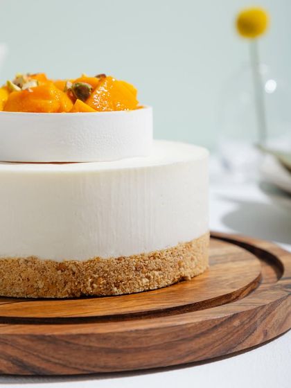 A close-up of our Cold Mango Cheesecake, showing the smooth, creamy texture and buttery biscuit base.