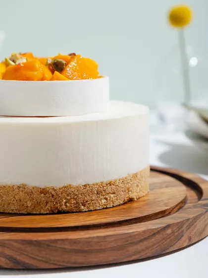 A close-up of our Cold Mango Cheesecake, showing the smooth, creamy texture and buttery biscuit base.