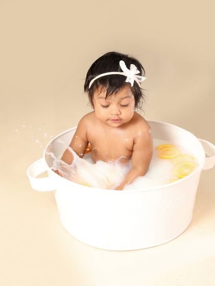 Splish, splash! This little one is having a blast making a splash in her milk bath. These action shots are so full of life.