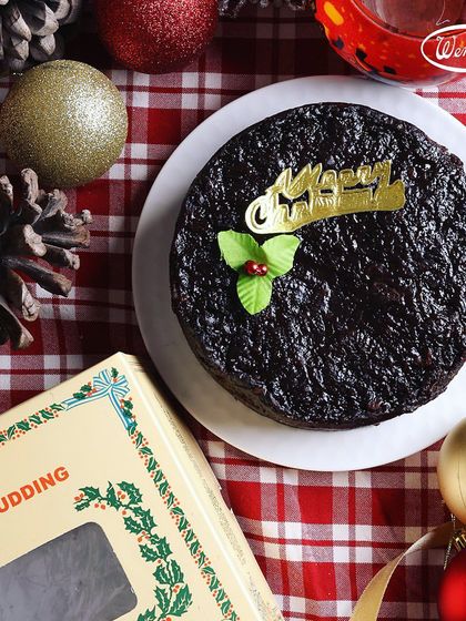 Our traditional Christmas Plum Pudding, dense with fruits and spices. It comes in our classic tin box, making it a perfect gift for the holiday season.