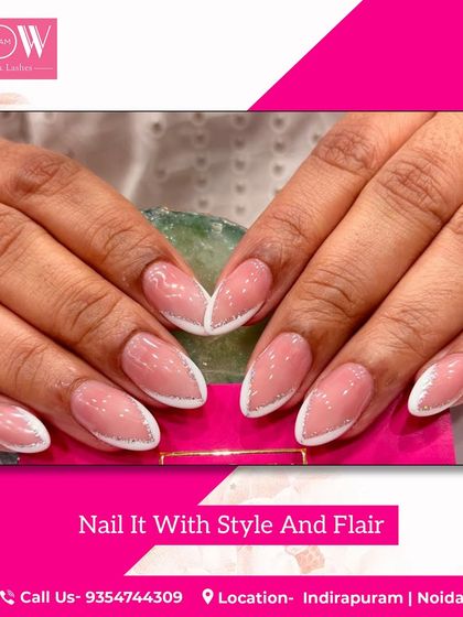 A modern twist on a French manicure, this design features a glittery silver V-tip on a soft pink base. It's a chic and stylish look for any nail length.