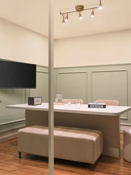 This is our primary discussion room, where we meet with clients. The space is designed to be comfortable and professional, with a large central table, bench seating, and good lighting for reviewing plans and materials.