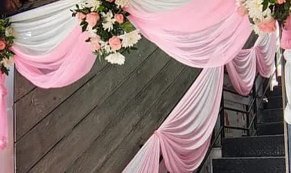 We pay attention to every detail, including decorating stairways with drapes and floral accents to create a cohesive look throughout the venue.