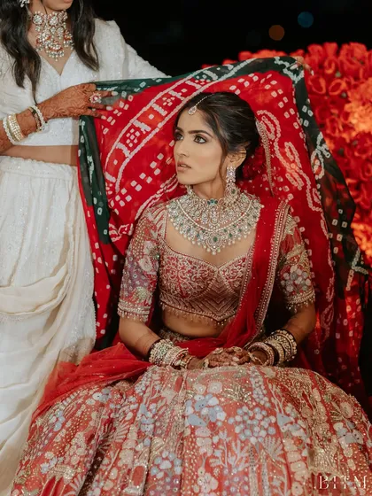 A regal shot of the bride during a wedding ritual. The makeup remains impeccable, showcasing its longevity and quality.