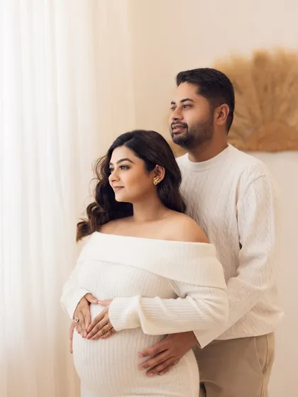 A classic portrait of the couple looking forward, symbolizing their shared journey into parenthood.