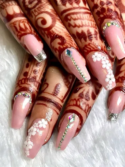 A perfect example of my custom bridal work, designed to complement intricate mehndi. This set features a soft pink base, delicate 3D floral accents, and sparkling crystal placements for a look that's both romantic and glamorous.