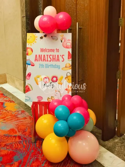 Welcome to Anaisha's 7th Birthday Pool Party! A personalized welcome sign, accented with a fun bunch of colorful balloons, is the perfect way to greet guests and set the tone for a fun-filled day.