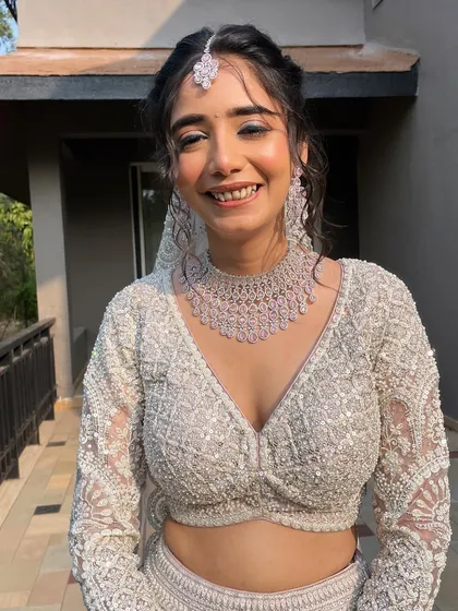 A beautiful portrait of my bride Alisha. Her makeup for this destination wedding features a soft glam eye and luminous skin, complementing her intricate white lehenga.