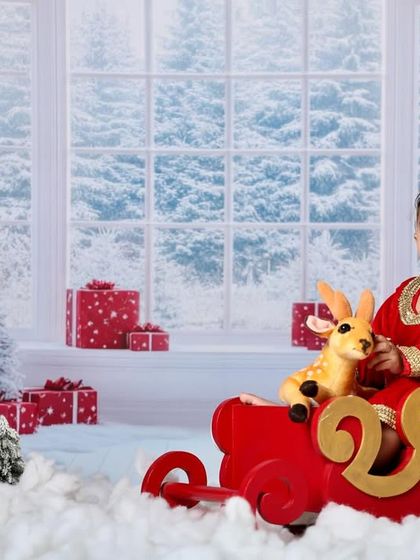 A sweet and simple portrait of a baby enjoying the festive Christmas scene.