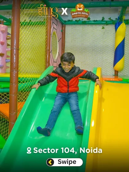 A young adventurer enjoys a solo trip down one of our bright and speedy slides. The slides are a central feature of the play area and a constant source of excitement.