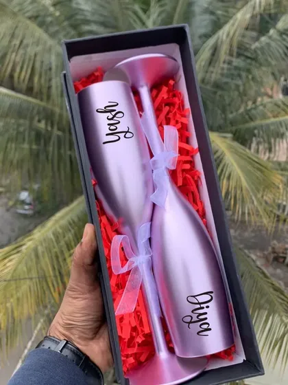 Toast to your love with these personalized non-breakable champagne flutes. Engraved with your names, they come in a beautiful gift box, making them a perfect anniversary or wedding gift.