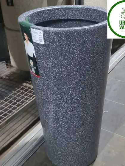 A tall, cylindrical fiber pot with a stone finish. This is one of my top 10 beautiful pot designs, perfect for a modern aesthetic.