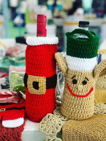 A Santa and reindeer bottle cover, perfect for gifting wine during the Christmas season.