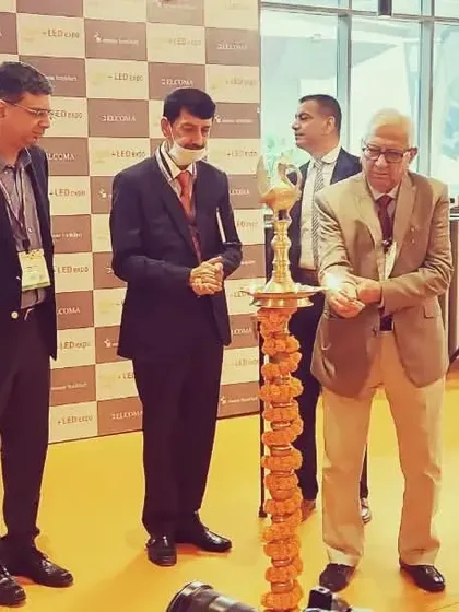 The lamp lighting ceremony in progress, with several industry leaders participating. This tradition is a cornerstone of our event, symbolizing the dispelling of darkness with the light of innovation.