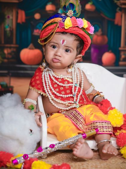 Even with a little pout, this baby makes an adorable Krishna. Not every photo has to be a smile; these expressions have their own charm.