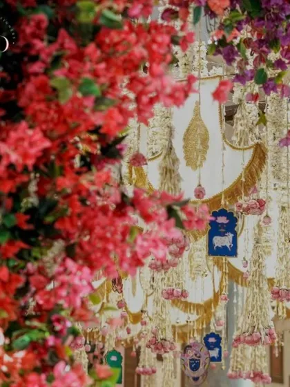 A cascade of bougainvillea and traditional hangings creates a vibrant and festive atmosphere for a Bhajan Sandhya, blending color with spirituality.