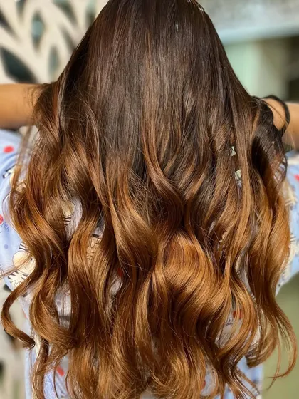 A close-up of the copper ombre, showing the richness of the color and the healthy shine of the hair.
