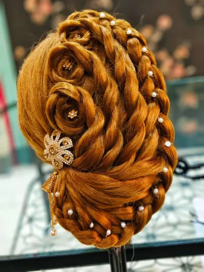 An advanced hairstyle featuring braided roses and pearl details. This kind of artistry is what I teach my students and offer to my clients for a truly unique look.