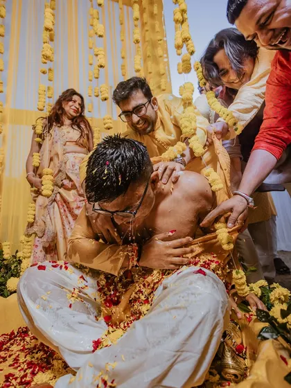 The groom's friends and family playfully applying haldi, a moment of pure fun and chaos that we love to capture.