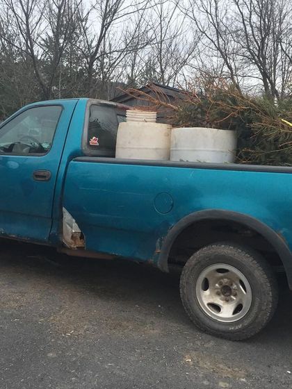 Our "new" old pickup truck, loaded with barrels and Christmas trees for composting. We keep the pickups going no matter what, even when it's freezing cold.