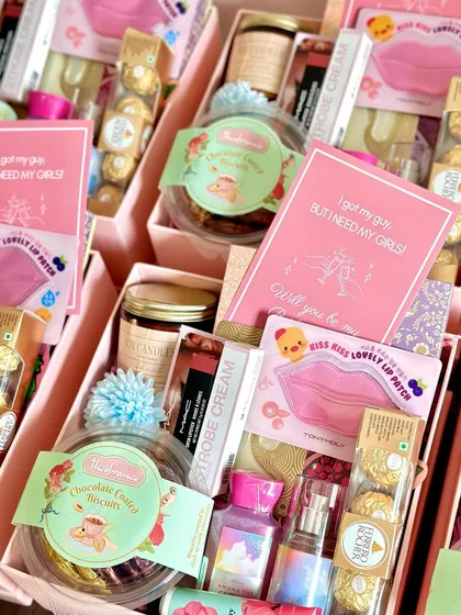 A detailed shot of the luxury bridesmaid hamper, showing the arrangement of high-end skincare, makeup, and gourmet treats.