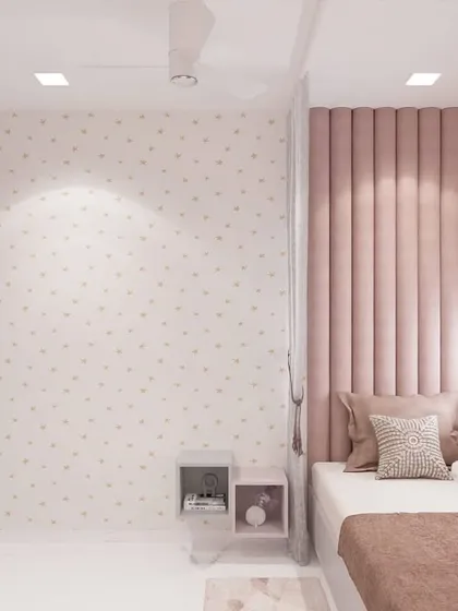 This bedroom for a teenage girl uses a soft, dusty rose color for the vertically tufted wall panel, creating a sophisticated feature behind the bed. The polka dot wallpaper adds a touch of playfulness to the otherwise elegant and calm design.