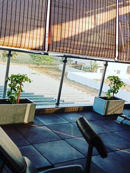 Custom planters placed in a gym with bamboo blinds, creating a serene and natural environment for exercise.