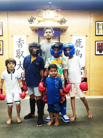 The kids' MMA sparring group, all geared up and ready to learn. Safety is our top priority, so we always use protective gear for drills.