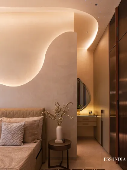 This bedroom showcases the art of layering textures for depth. A sculptural wave detail on the wall, an embossed leather headboard, and a mix of textiles on the bed create a rich, inviting, and tactile experience.