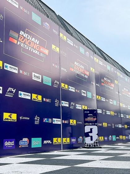 A massive branding wall at the Indian Racing Festival, showcasing the numerous sponsors. We handle all branding implementation to maximize partner visibility.