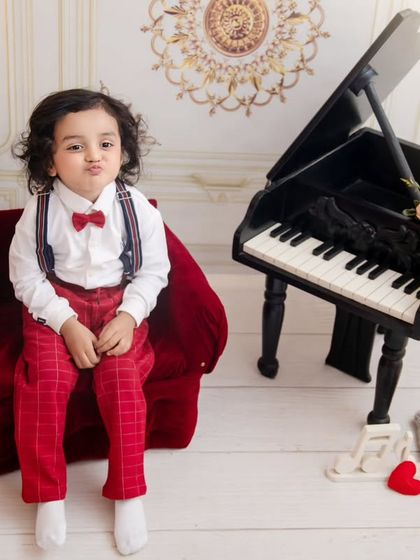 A pouting pretty boy. This little guy's adorable expression is the focus of this charming and classic studio portrait.