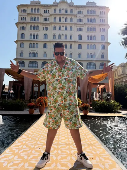The grand facade of the hotel behind me. We play at some of the most beautiful locations.