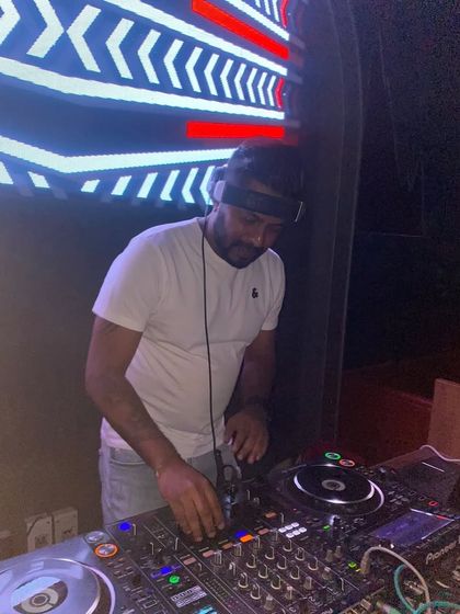 A clear shot of me at work, with my hands on the controls against the backdrop of an LED screen.