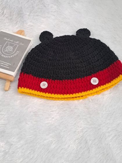 A close-up of the Mickey Mouse inspired beanie from one of my gift hampers. It features the iconic ears and colors, all crocheted with soft, baby-friendly yarn.