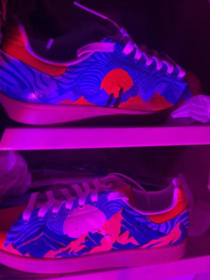 The trippy Stan Smiths under a blacklight. The colors are UV-reactive, so the design completely transforms and glows in the dark.