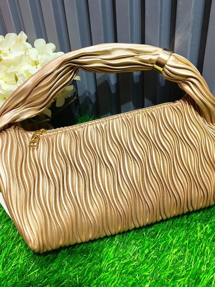 The same popular ruched handle bag, shown here in a versatile gold color. It can be paired with a wide range of traditional and western outfits.