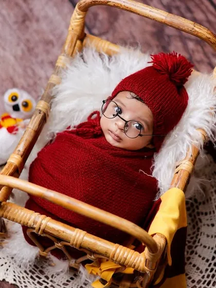 For the family of fans, we offer creative themed sessions like this popular Harry Potter setup. We provide all the props, from the tiny glasses and scarf to the miniature books and magical owl.