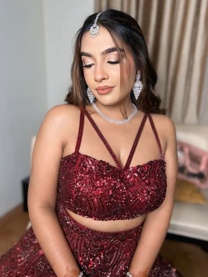 A close-up of the eye makeup for this red engagement look. The soft shimmer and defined lash line make her eyes sparkle.