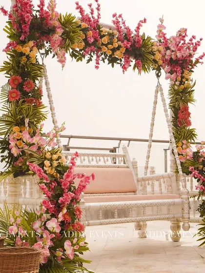 A beautifully decorated floral swing, perfect for post-ceremony photos or as unique seating for the bride and groom. The vibrant flowers create a stunning visual against any backdrop.
