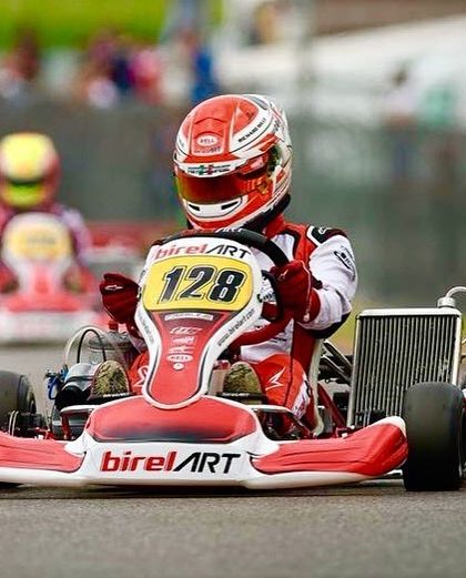 A classic shot of a Birel ART kart, number 128, on the track, representing our brand's long history of racing excellence.