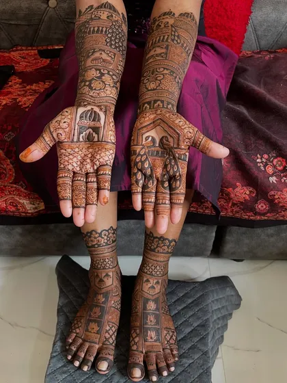 A full view of a bride's hands and feet, showing how the designs are coordinated. The peacock and palace theme is carried through from her arms to her legs.