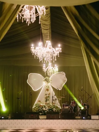 Pre-wedding events are a chance to be creative and bold. For this "Big Bow Affair," I designed a chic and dramatic stage with a statement illuminated bow, setting the perfect tone for a glamorous night of celebration.