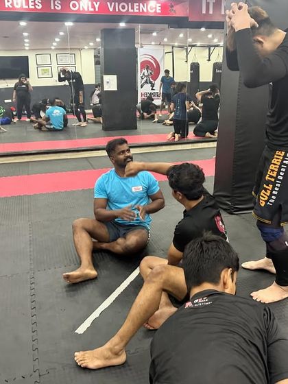 After a tough roll, students and coaches discuss techniques and share feedback. This collaborative learning environment is at the heart of our BJJ program.