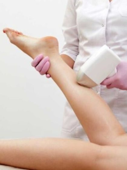 This image captures a moment during a leg laser hair removal session. My goal is to make your journey to smooth skin a comfortable and successful one, using my expertise as a board certified dermatologist.