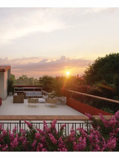 The terrace of the 'Red Haus' is a space designed for connection, perfect for enjoying evening sunsets with coffee. Surrounded by bougainvilleas, it’s a simple yet beautiful extension of the living area, blurring the lines between inside and out.