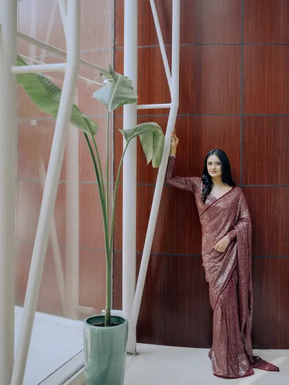 An architectural shot that frames the bride and her beautiful engagement saree perfectly.