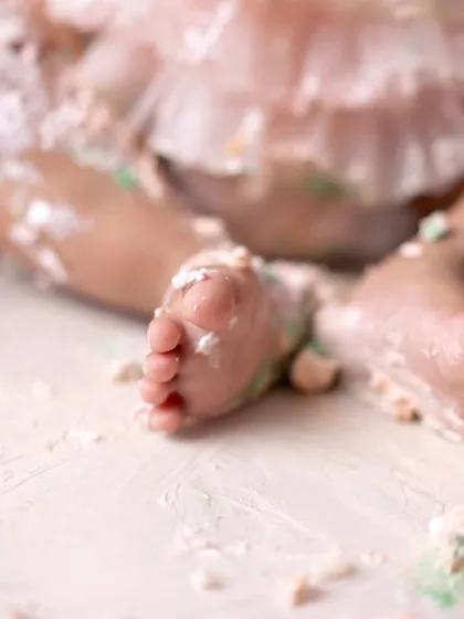 A close-up of the best part of a cake smash: the messy feet! A sweet reminder of a fun-filled day.