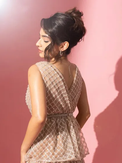 A profile view that showcases the elegant updo and the delicate line of her neck and shoulders.